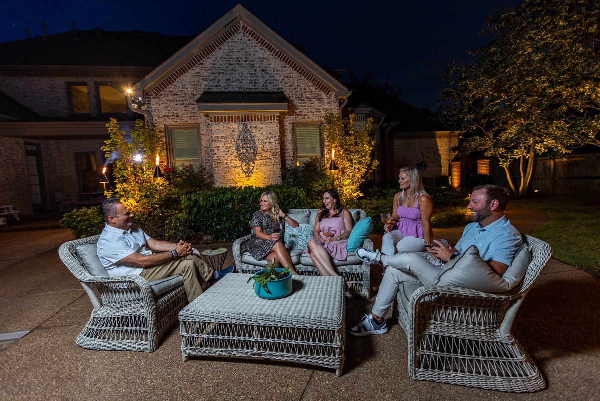 Backyard party enjoying outdoor landscape lights