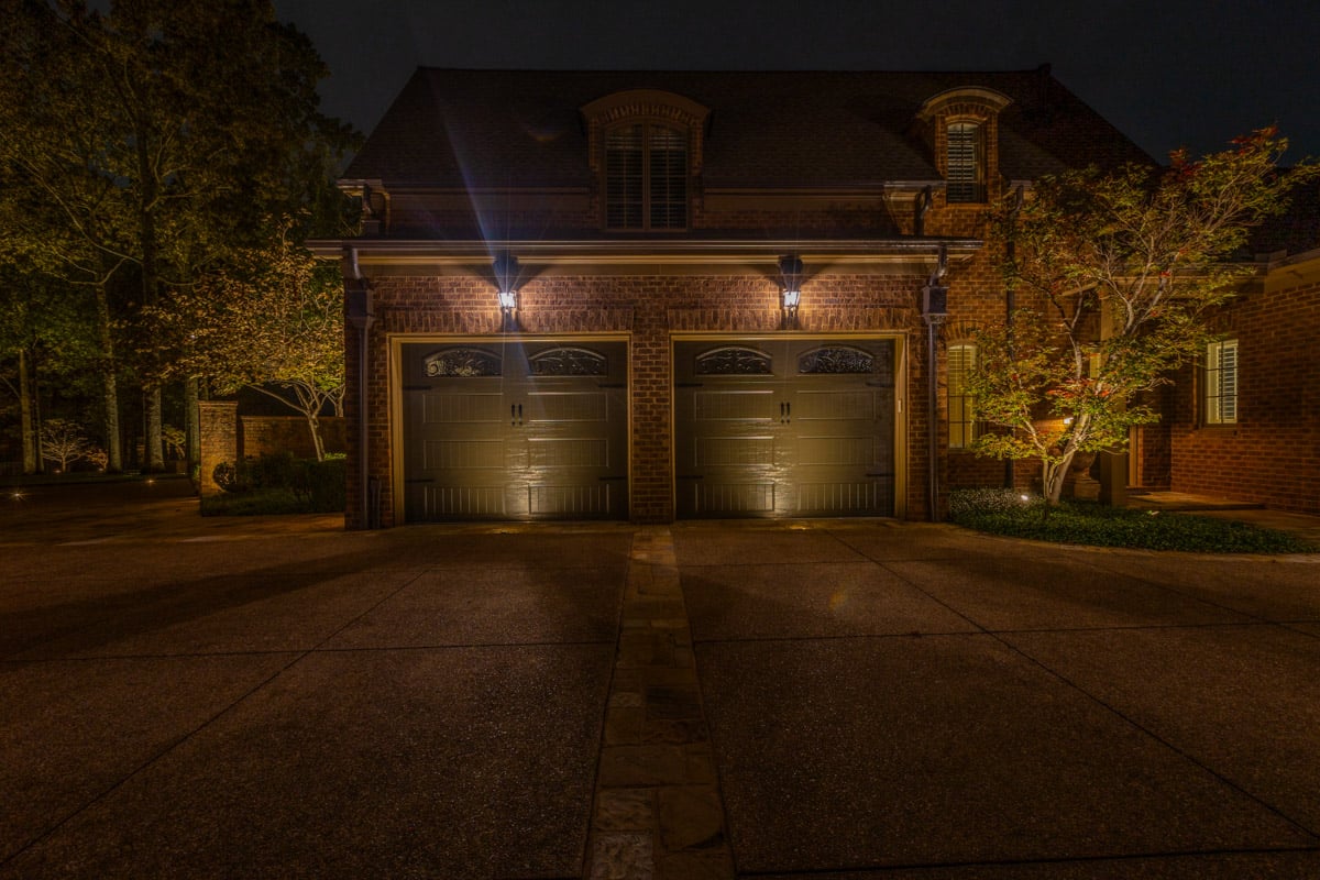 Residential landscape lighting garage door tree uplighting