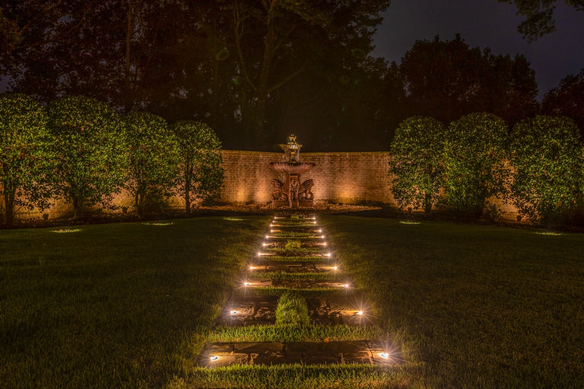 Residential landscape walkway and fountain lighting with lights in path