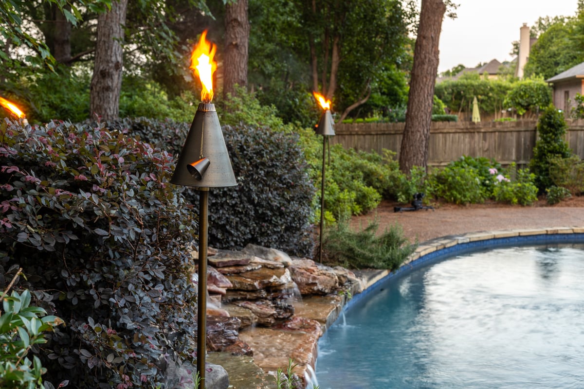 Tiki Torch lights by vacation home pool