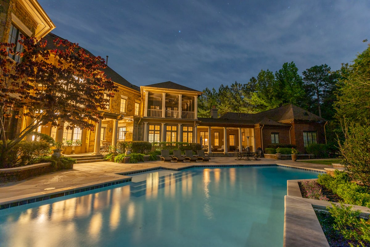 backyard with pool with lighting