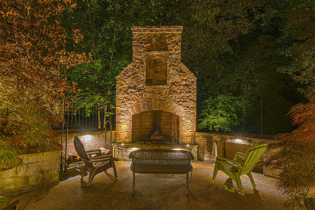 outdoor fireplace area with lighting