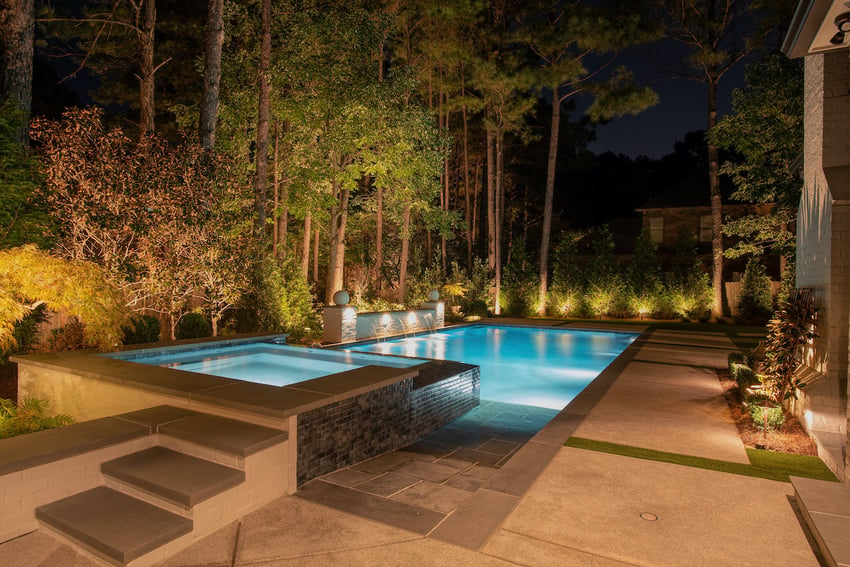 Pool patio with outdoor lighting at night