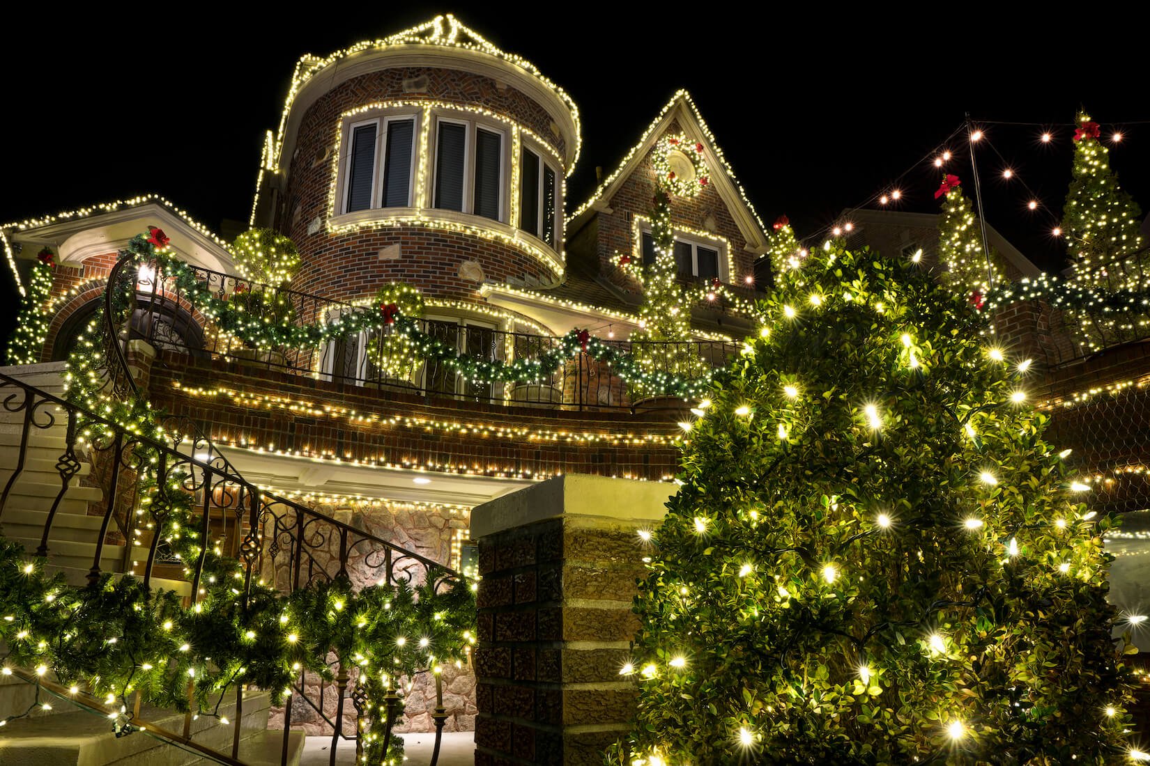 large home with holiday lights